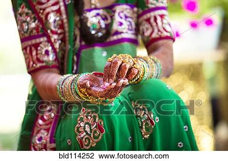 Stock Image - Woman wearing traditional Indian henna and robes. Fotosearch