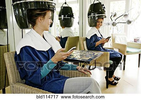 Stock Photo - Women having hair done in salon. Fotosearch