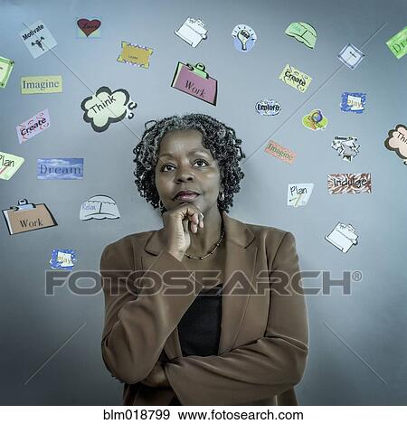 Stock Photo - African American businesswoman surrounded by symbols. Fotosearch