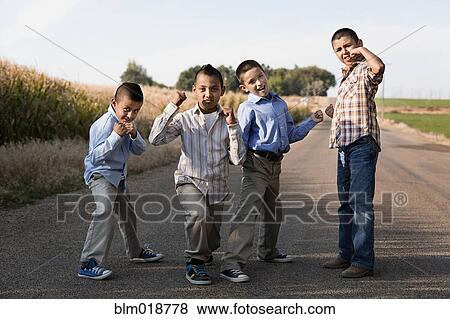 Boys posing together on rural road View Large Photo Image Stock Photo - Boys posing together on rural road. Fotosearch