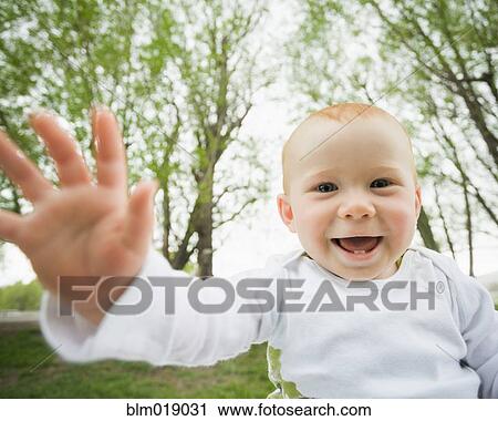 Caucasian baby laughing outdoors View Large Photo Image Stock Image - Caucasian baby laughing outdoors. Fotosearch