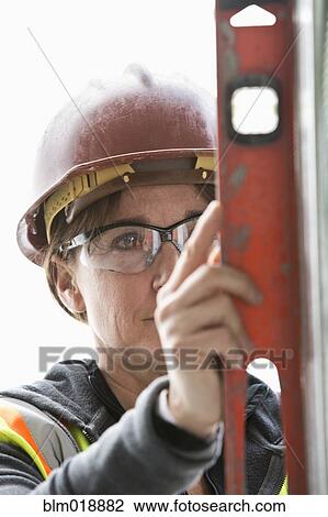 Caucasian construction worker using level View Large Photo Image Stock Image - Caucasian construction worker using level. Fotosearch