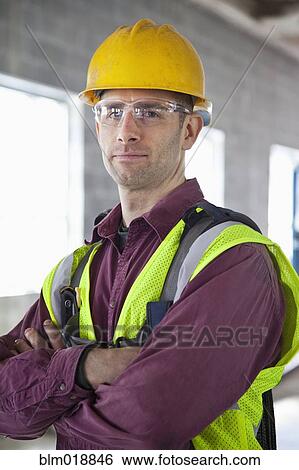 Stock Photograph - Caucasian construction worker with arms crossed. Fotosearch