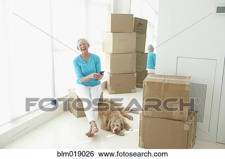 Caucasian woman laughing in new home View Large Photo Image Stock Photograph - Caucasian woman laughing in new home. Fotosearch