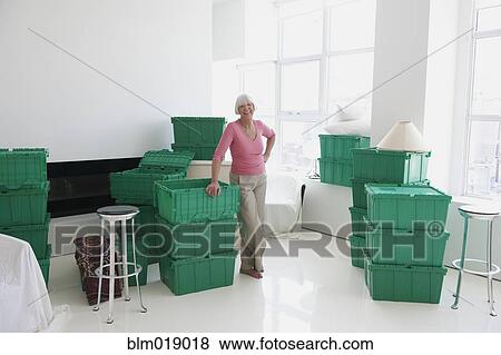 Caucasian woman smiling in new home View Large Photo Image Stock Photo - Caucasian woman smiling in new home. Fotosearch