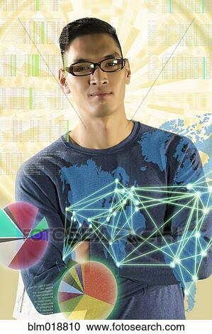 Stock Image - Chinese man standing with illuminated holograms. Fotosearch