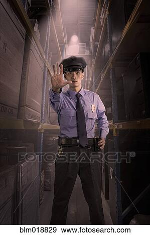 Stock Photo - Chinese police officer working in warehouse. Fotosearch