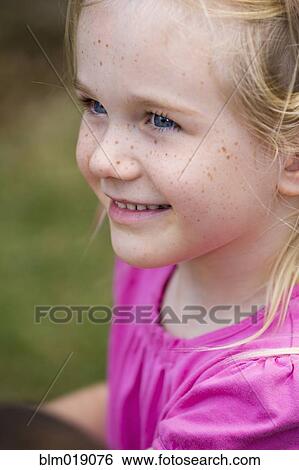 Stock Photograph - Close up of smiling girl's face. Fotosearch