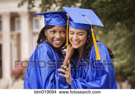 Picture - College graduates smiling together. Fotosearch