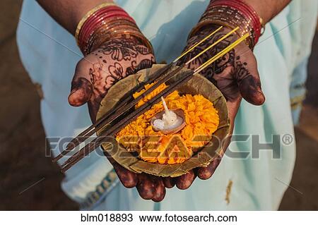 Stock Image - Decorated hands holding traditional offering, Allahabad, Uttar Pradesh, India. Fotosearch