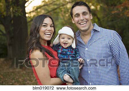Stock Image - Family smiling together outdoors. Fotosearch