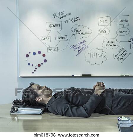 Filipino businesswoman laying on desk View Large Photo Image Stock Photo - Filipino businesswoman laying on desk. Fotosearch