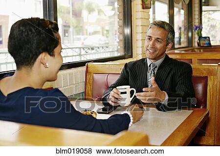 Hispanic business people talking in restaurant View Large Photo Image Stock Photo - Hispanic business people talking in restaurant. Fotosearch