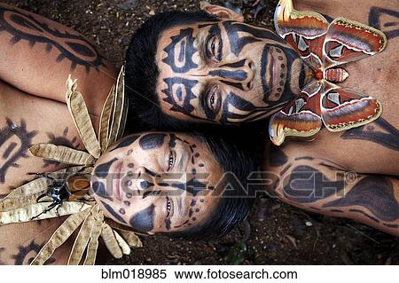 Stock Photography - Hispanic couple with painted faces and decorative necklaces, Lago Izabal, Guatemala. Fotosearch