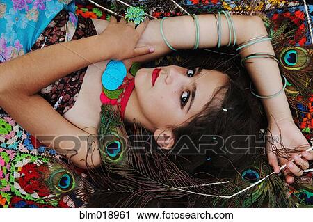 Stock Image - Hispanic girl wearing bracelets and necklace. Fotosearch