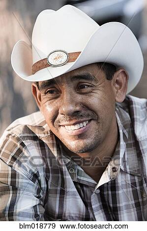 Hispanic man smiling in cowboy hat View Large Photo Image Stock Photo - Hispanic man smiling in cowboy hat. Fotosearch