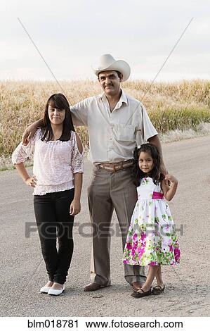 Hispanic man smiling with daughters View Large Photo Image Stock Image - Hispanic man smiling with daughters. Fotosearch