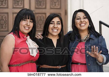 Stock Photo - Hispanic women smiling together. Fotosearch
