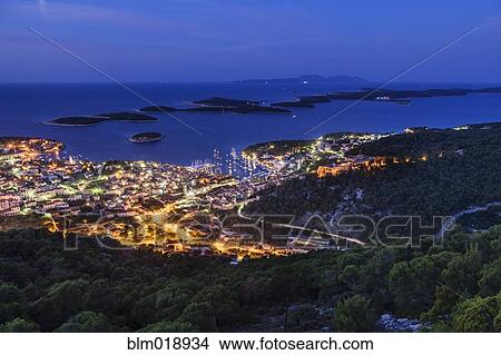 Illuminated city skyline at dusk, Hvar Island, Croatia View Large Photo Image Picture - Illuminated city skyline at dusk, Hvar Island, Croatia. Fotosearch
