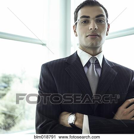 Stock Image - Middle Eastern businessman with arms crossed. Fotosearch