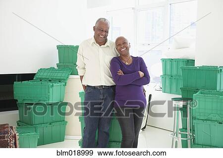 Older Black couple smiling in new home View Large Photo Image Stock Photo - Older Black couple smiling in new home. Fotosearch