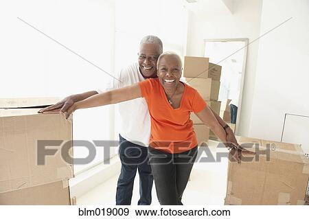 Older Black couple smiling in new home View Large Photo Image Stock Photo - Older Black couple smiling in new home. Fotosearch
