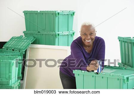 Older Black woman smiling in new home View Large Photo Image Stock Image - Older Black woman smiling in new home. Fotosearch