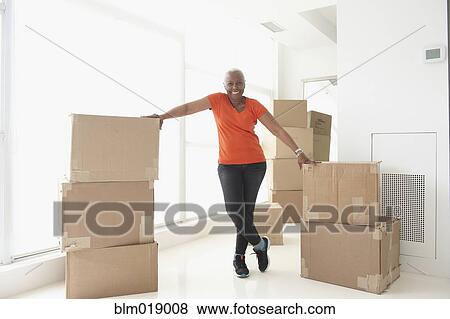 Stock Photo - Older Black woman smiling in new home. Fotosearch