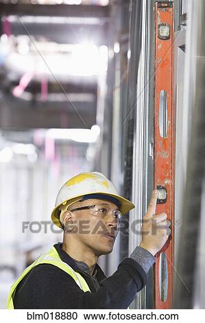 Stock Image - Pacific Islander construction worker at construction site. Fotosearch