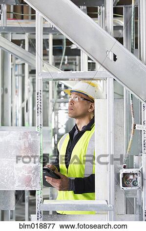 Pacific Islander construction worker making notes View Large Photo Image Stock Photo - Pacific Islander construction worker making notes. Fotosearch