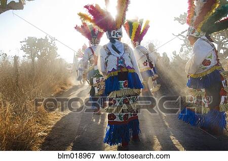 Stock Photo - People wearing colorful traditional clothing outdoors. Fotosearch