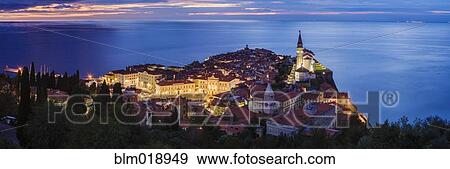 Stock Photo - Piran city skyline illuminated at night, Piran, Slovenia. Fotosearch