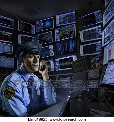 Stock Photography - Police officer working in control room. Fotosearch