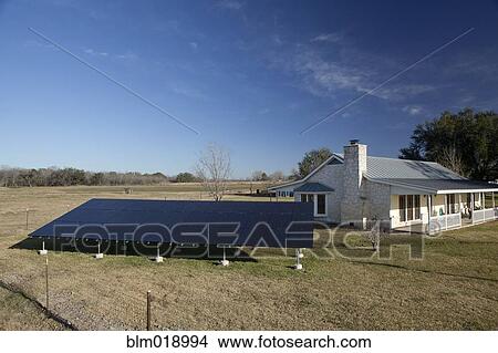 Solar panels outside home in rural landscape View Large Photo Image Picture - Solar panels outside home in rural landscape. Fotosearch