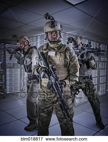 Stock Photo - Soldiers holding guns in server room. Fotosearch