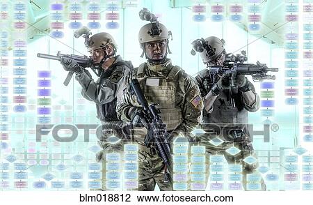 Stock Image - Soldiers pointing gun at illuminated holograms. Fotosearch