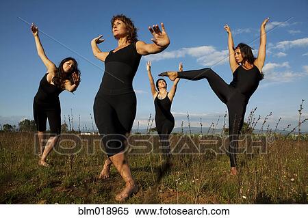 Stock Photography - Women dancing in tall grass. Fotosearch