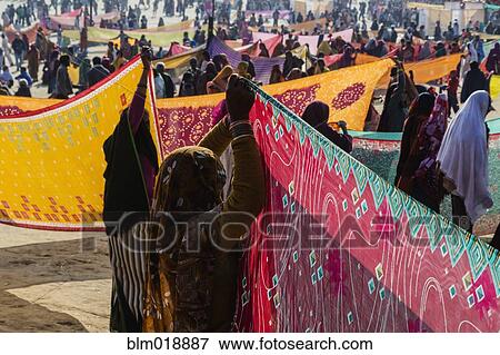 Women holding colorful fabric at festival, Allahabad, Uttar Pradesh, India View Large Photo Image Stock Photo - Women holding colorful fabric at festival, Allahabad, Uttar Pradesh, India. Fotosearch