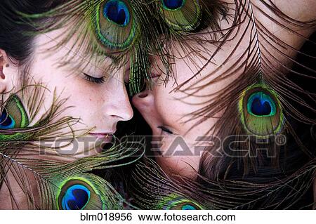 Women surrounded by peacock feathers View Large Photo Image Stock Photograph - Women surrounded by peacock feathers. Fotosearch