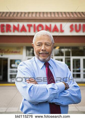 African American businessman smiling outside grocery store View Large Photo Image Stock Photograph - African American businessman smiling outside grocery store. Fotosearch