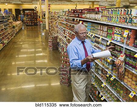 Stock Photography - African American businessman working in grocery store. Fotosearch