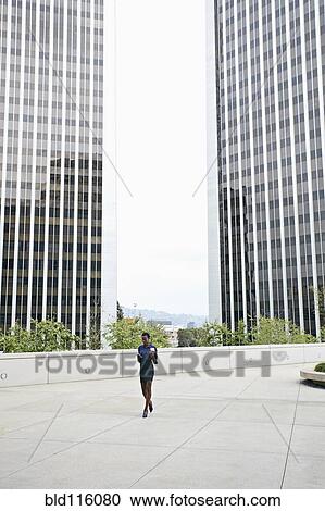 African American businesswoman walking on city street View Large Photo Image Stock Image - African American businesswoman walking on city street. Fotosearch