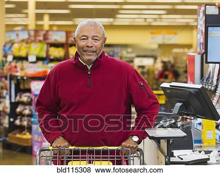 Stock Photo - African American customer at grocery store checkout. Fotosearch