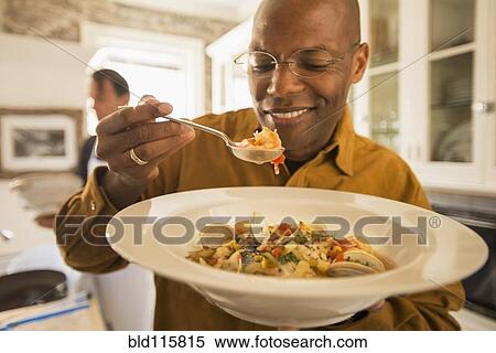 African American man eating seafood stew View Large Photo Image Stock Photography - African American man eating seafood stew. Fotosearch