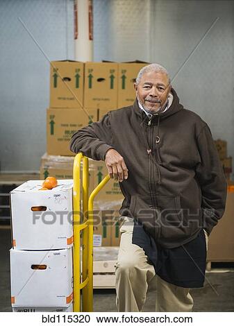 African American worker carting boxes in walk-in freezer View Large Photo Image Stock Image - African American worker carting boxes in walk-in freezer. Fotosearch
