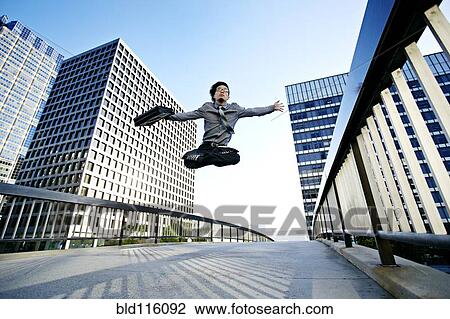 Asian businessman leaping on urban walkway View Large Photo Image Stock Image - Asian businessman leaping on urban walkway. Fotosearch