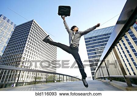 Asian businessman leaping on urban walkway View Large Photo Image Stock Image - Asian businessman leaping on urban walkway. Fotosearch