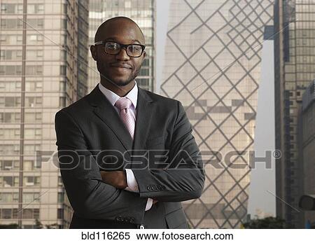 Black businessman smiling on city street View Large Photo Image Stock Photography - Black businessman smiling on city street. Fotosearch