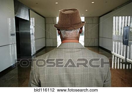 Stock Image - Black businessman standing in office. Fotosearch