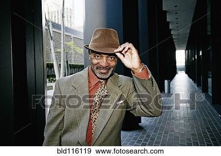 Black businessman tipping his hat View Large Photo Image Stock Photo - Black businessman tipping his hat. Fotosearch